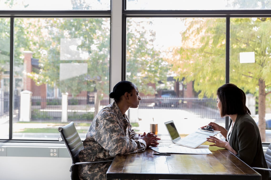 Loan officer reviews loan application with veteran